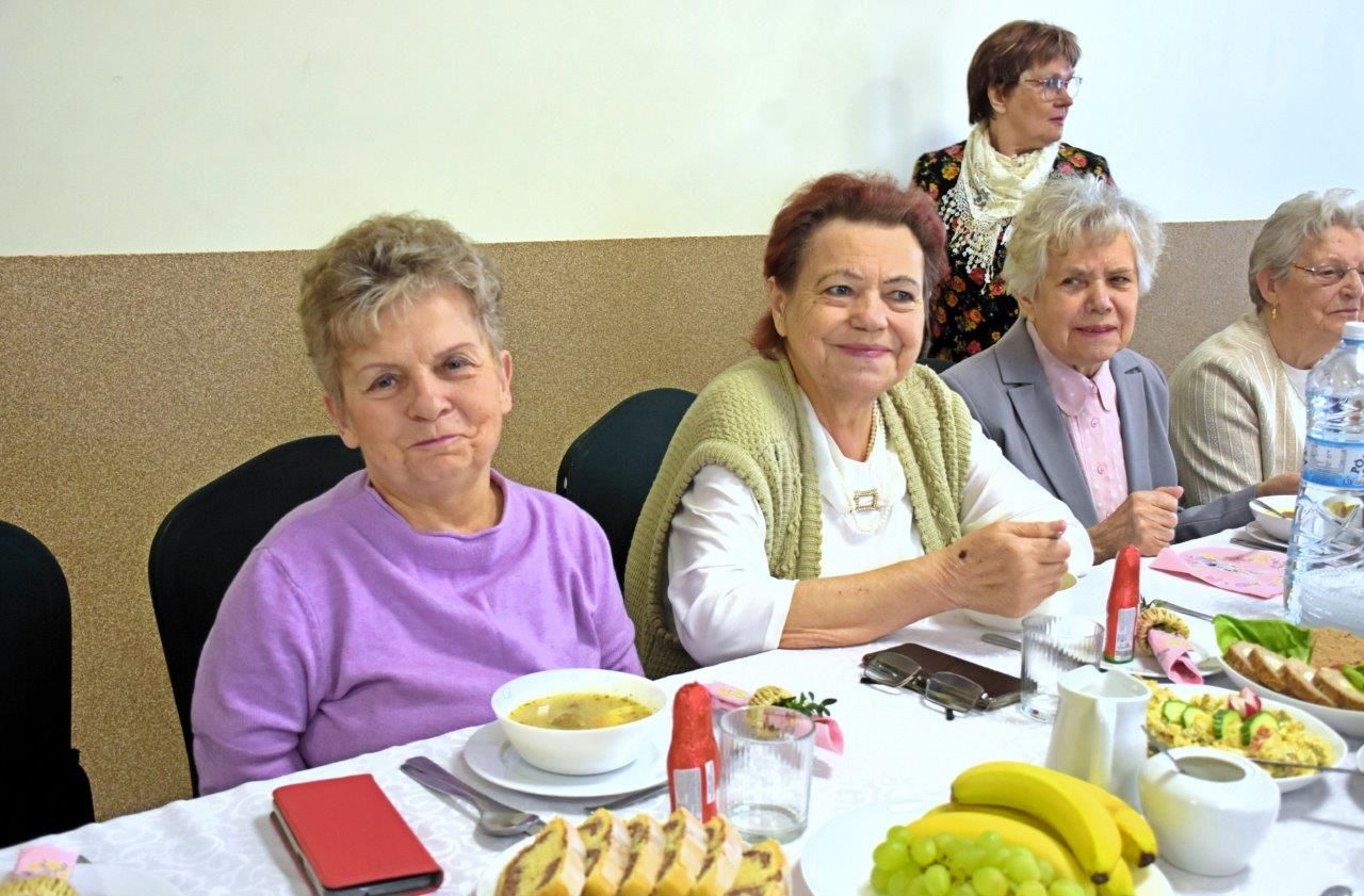 zdjęcie przedstawia ludzi siedzących przy stole